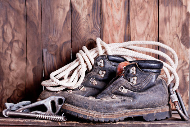 istock Old mountain boots with rope and climbing accessories 954229748