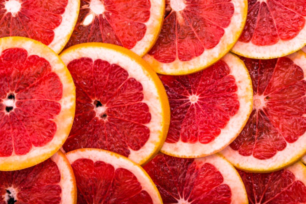 istock Sliced grapefruits, background, natural texture of citrus, top view, close-up 954231564