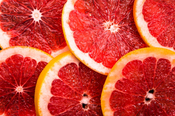 istock Sliced grapefruits, background, natural texture of citrus, top view, close-up 954231708