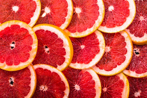istock Sliced grapefruits, background, natural texture of citrus, top view, close-up 954231796