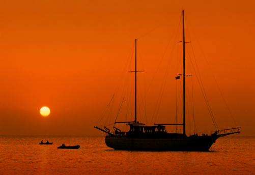 Albion, Mauritius - October 04, 2022: Silhouette of a boat at the beach in the West of Mauritius during sunset.