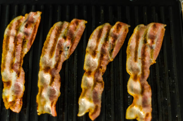 istock thin slices of delicious bacon fried on the grill, crispy and delicate meat 954235156