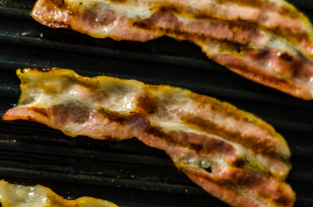 istock thin slices of delicious bacon fried on the grill, crispy and delicate meat 954235294