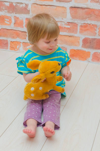 istock child, girl with pacifier and candy on a stick 954239564