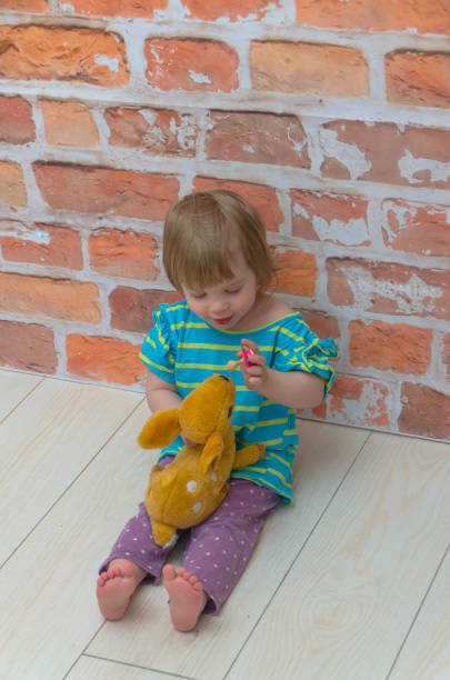istock child, girl with pacifier and candy on a stick 954239602