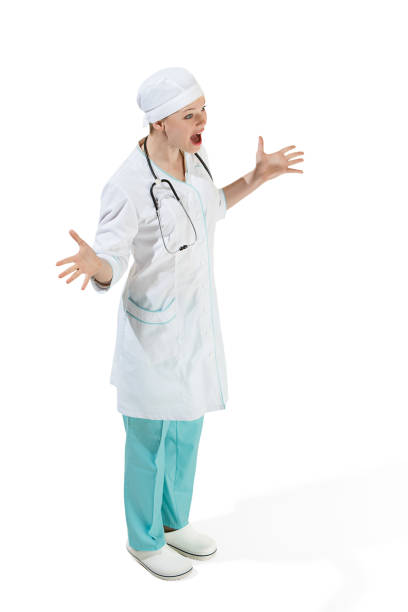 istock Beautiful young woman is surprised in white coat posing at studio. Full length studio shot isolated on white 954239608