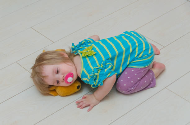 istock child, girl with pacifier and candy on a stick 954239622