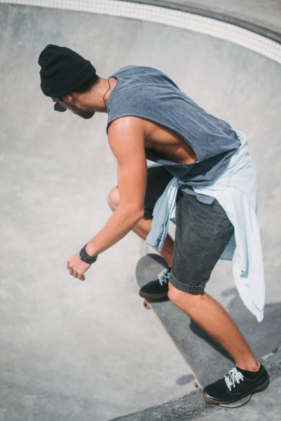 istock side view of sportive skater on longboard 954239712
