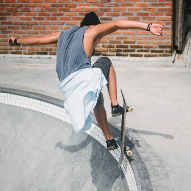 istock back view of skater jumping with longboard 954240358