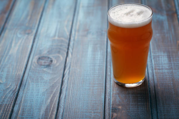 istock Pale ale on blue wood 954240518