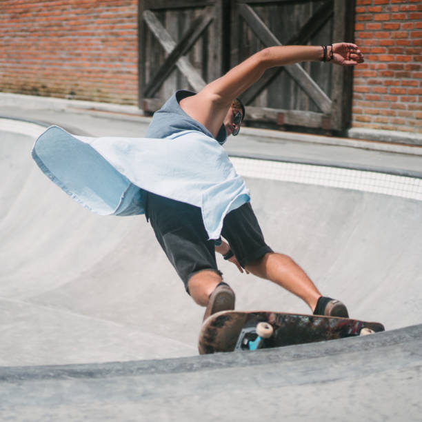 istock young skater skating on longboard at skatepark 954240570