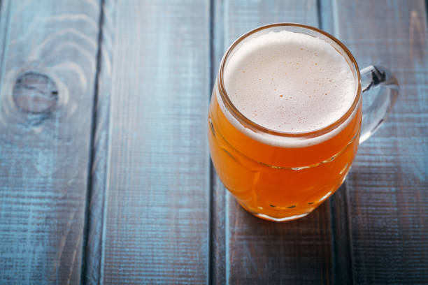 istock Pale ale on blue wood 954240628