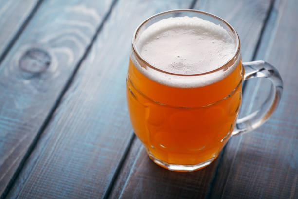 istock Pale ale on blue wood 954240684