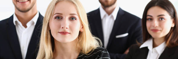 istock Group of smiling people stand in office looking 954240924