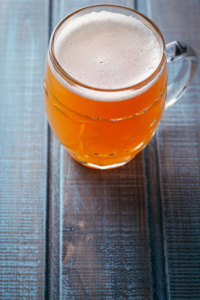 istock Pale ale on blue wood 954242420