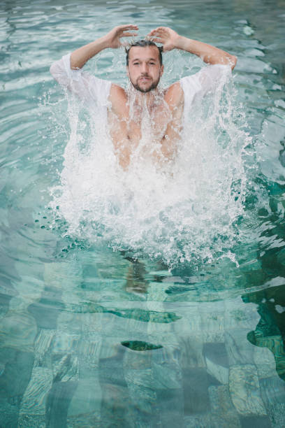 istock handsome man jumping in swimming pool in Bali, Indonesia 954248746