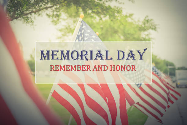 Text Memorial Day and Honor on row of lawn American Flags stock photo