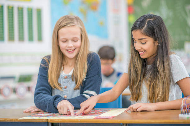 istock Girls having fun learning together in elementary school 954249810