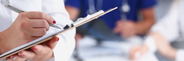 istock Female doctor hold clipboard pad and fill 954251154