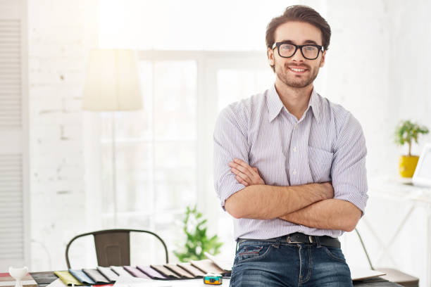 istock Happy businessman standing near the table 954251916