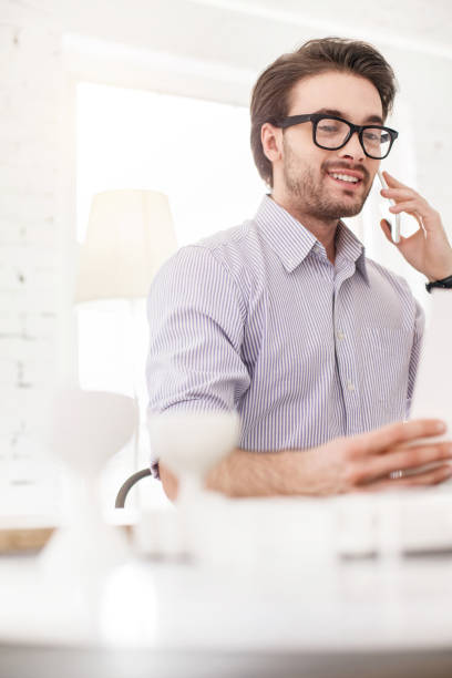 istock Smiling worker talking on the phone 954252364