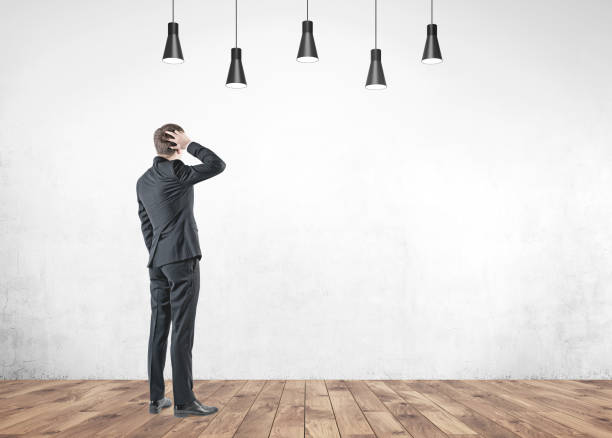 istock Confused businessman, rear view, concrete 954255508