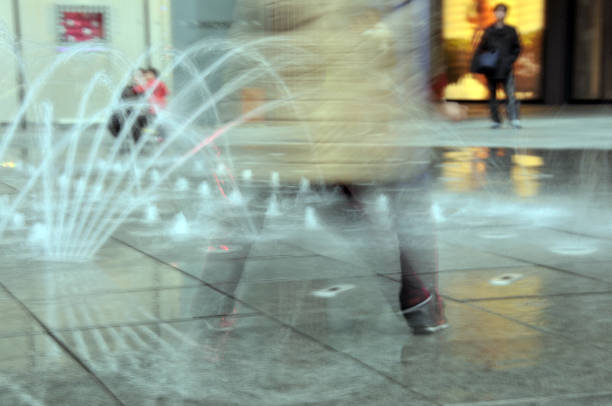 istock Child plays with water fountain 954256632