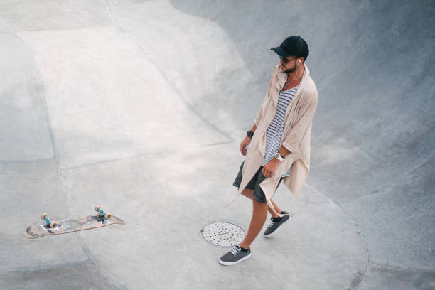 istock handsome skater looking at falling skate 954258326
