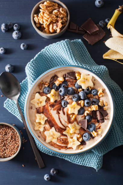 istock healthy banana smoothie bowl with blueberry chocolate walnuts 954259380