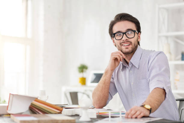 istock Cheerful businessman sitting at the table 954260256