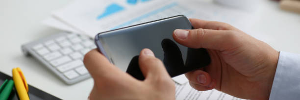istock A businessman holds a new smartphone in his hand 954261148