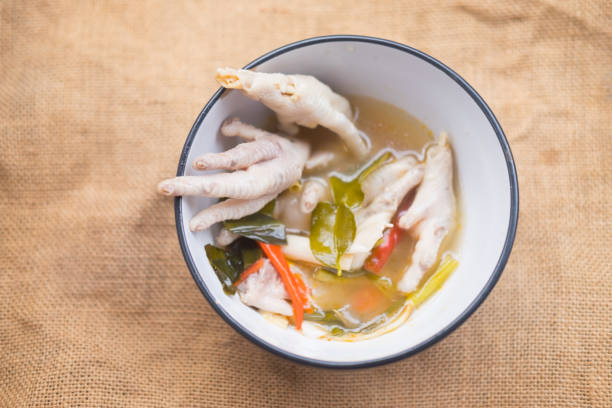 istock Chicken feet Thai hot soup tom yam in bowl 954261236