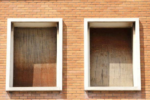 istock old windows with wood panels that need a renovation on a brick house 954261862