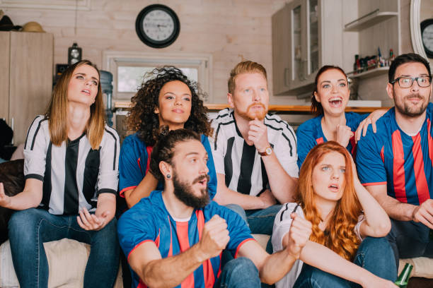istock Multi-gender group of soccer fans watching a game 954261924