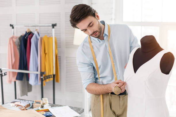 istock Joyful tailor working on a new dress 954262262