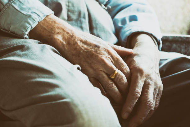 istock Senior man sitting on chair with his hands on knees 954265388