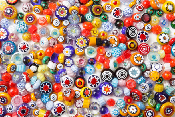 Collection of colorful glass beads. Colored Venetian, Murano glass, millefiori. Collection of colorful glass beads. Colored Venetian, Murano glass, millefiori. Isolated on white background. Flat lay, top view murano stock pictures, royalty-free photos & images