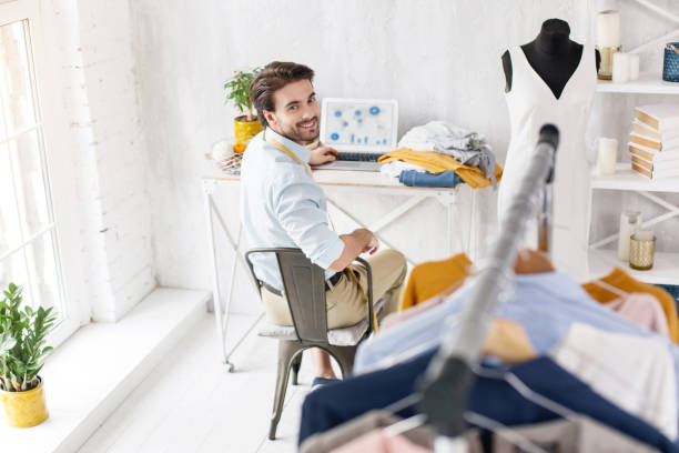 istock Exuberant dressmaker sitting at the table 954266278