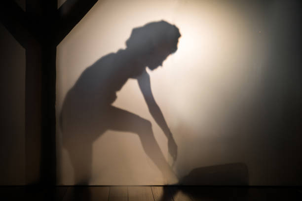 Portrait of woman shadow shaving her legs