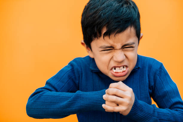 Angry Little boy making a fist Portrait of a little boy making a fist clenching teeth stock pictures, royalty-free photos & images
