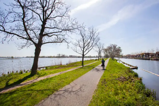 Photo of Bicycle path and footpath through water in the Netherlands