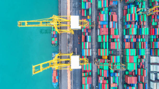 istock Container ship in export and import business and logistics. Shipping cargo to harbor by crane. Water transport International. Aerial view and top view 954271342