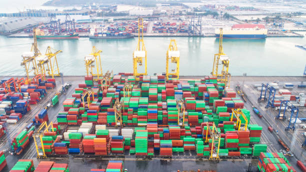 istock Container ship in export and import business and logistics. Shipping cargo to harbor by crane. Water transport International. Aerial view and top view 954271428