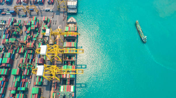 istock Container ship in export and import business and logistics. Shipping cargo to harbor by crane. Water transport International. Aerial view and top view 954271438