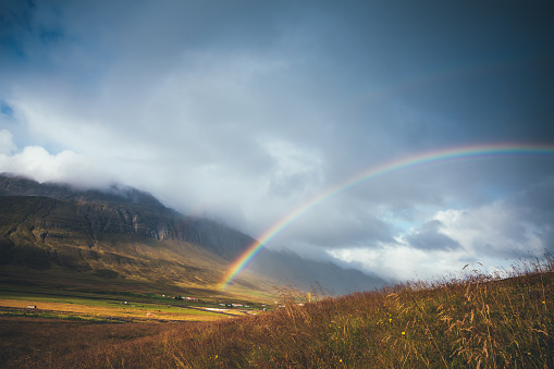 Rainbow over Icelandic landscape (fjord Nordfjordur, east Iceland).