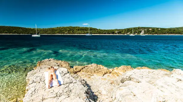 a regatta in the sea of CroatiaA beautiful blonde girl relaxing in the croatian sea