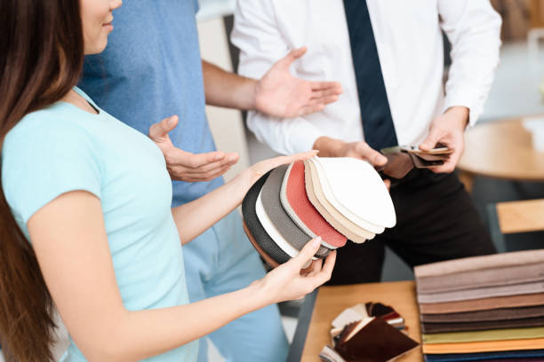 istock A young girl holds leather samples for a sofa. 954282200