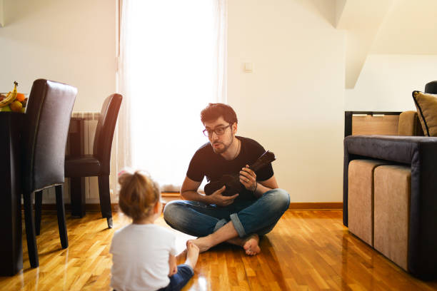istock Dad plays the guitar for his daughter 954285868