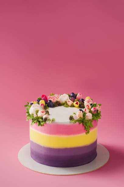 istock close up view of decorated cake isolated on pink 954286862