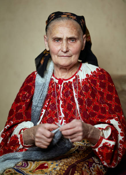 istock Old woman knitting 954290354